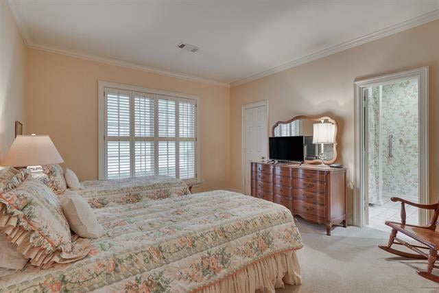 Bedroom with a floral bed, dresser and television, and an open doorway to a sitting area.