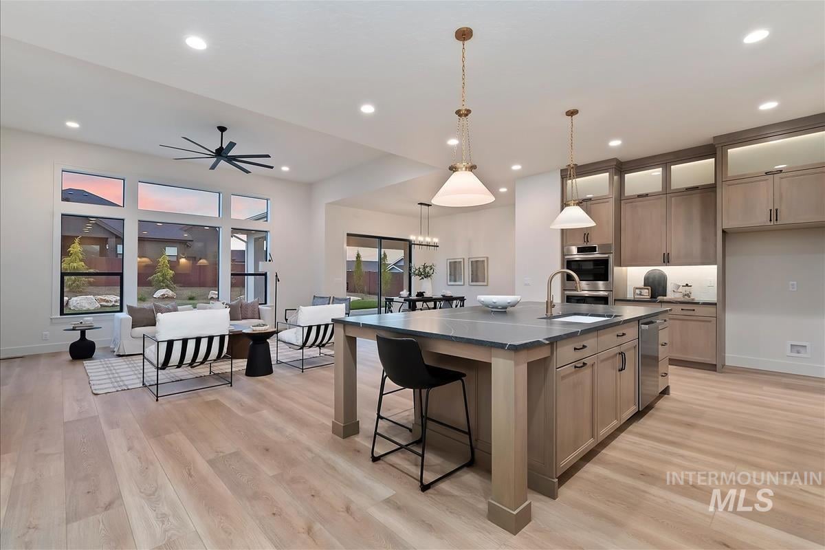 Wide shot of the kitchen, living room and dining room in an open concept home