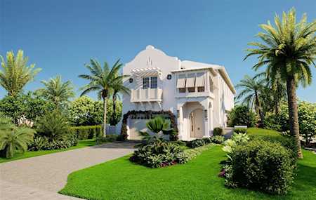 White two-story stucco home with arched details, a curved driveway, and palm-lined landscaping.