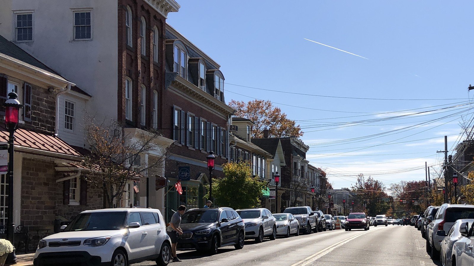 Historic storefronts along State Street under a clear blue sky in Newtown, PA