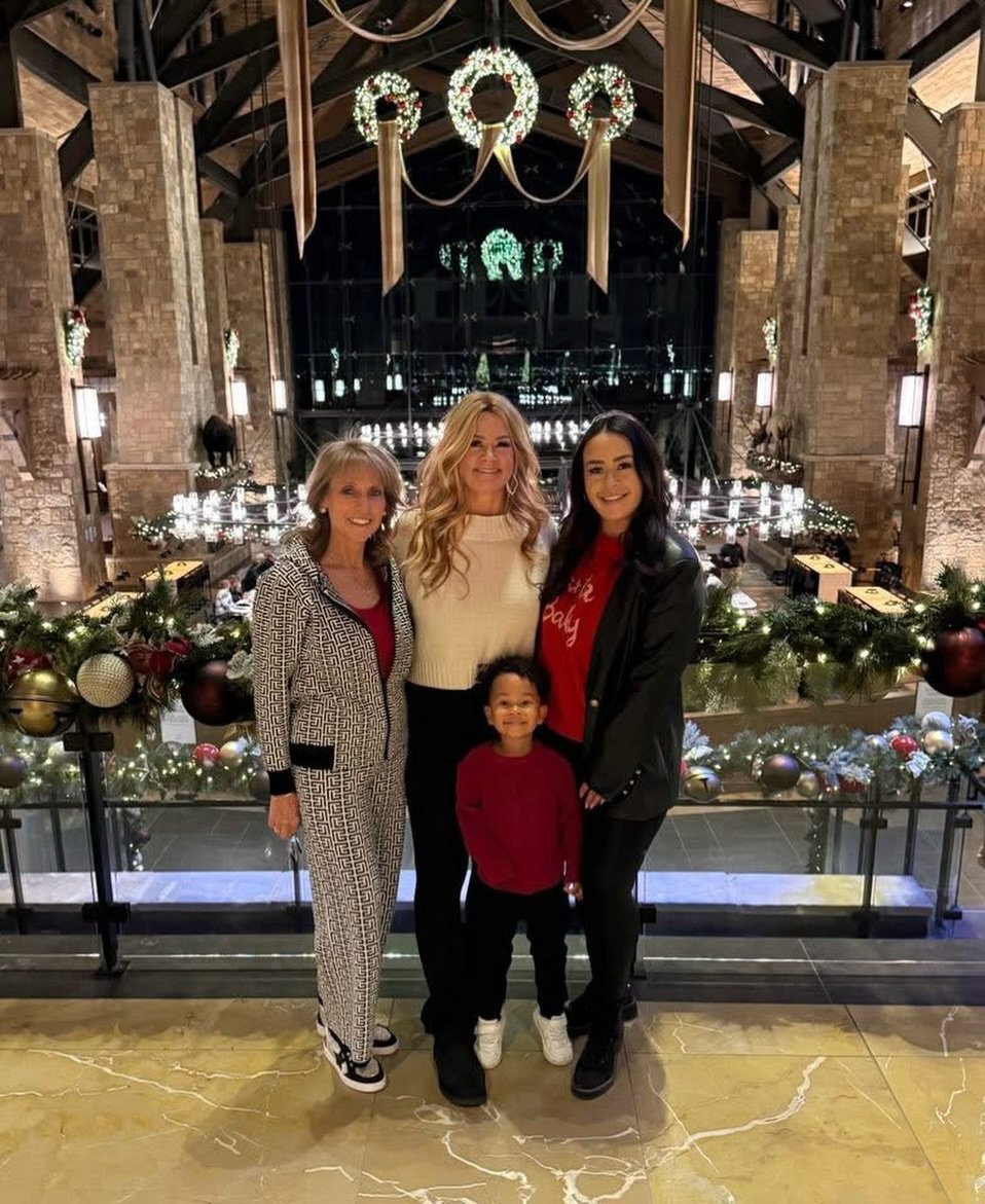 Holiday greeting from a real estate team with warm lights, festive décor, and text wishing families joy, memories, and togetherness this season.