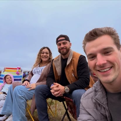Aaron with a family at an outdoor event