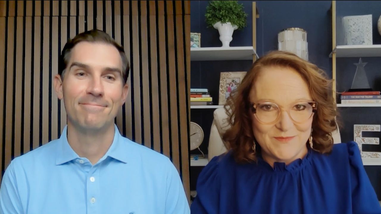 Two people in a split-screen interview; one wears a light blue polo, the other glasses and a blue blouse.