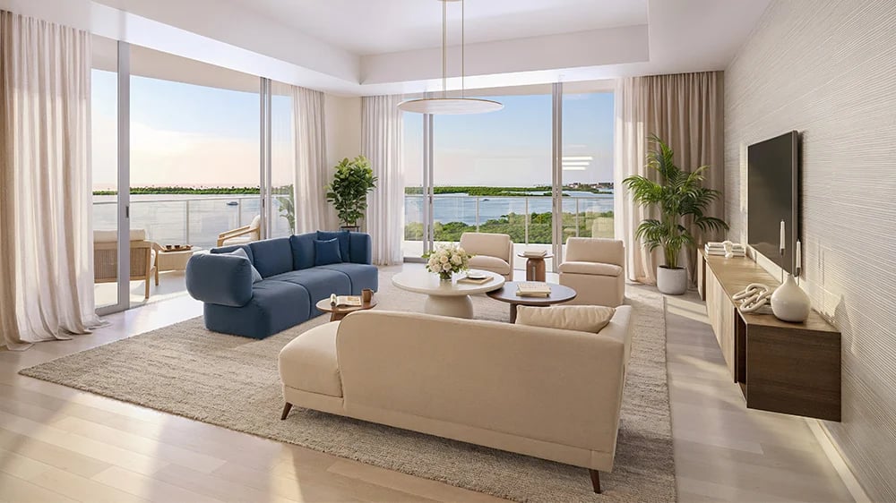 Luxury living room at The Ritz-Carlton Residences Estero Bay with floor-to-ceiling glass doors and panoramic bay views in Bonita Springs Florida