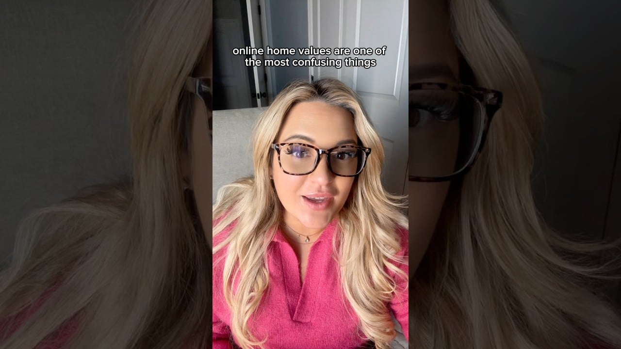 Blonde real estate agent in glasses and a pink top discusses online home values.