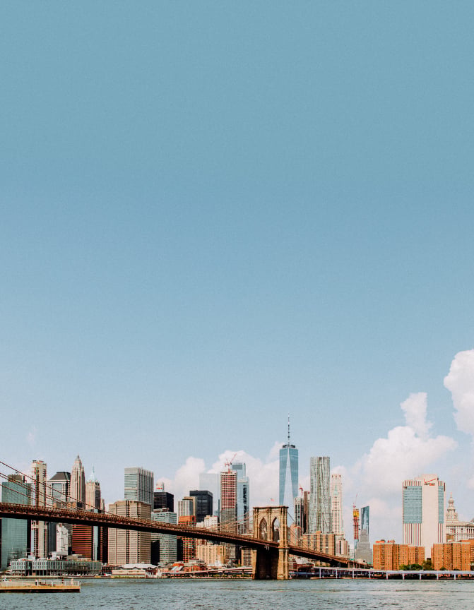 Downtown Manhattan and Brooklyn skyline at midday, viewed from the East River.