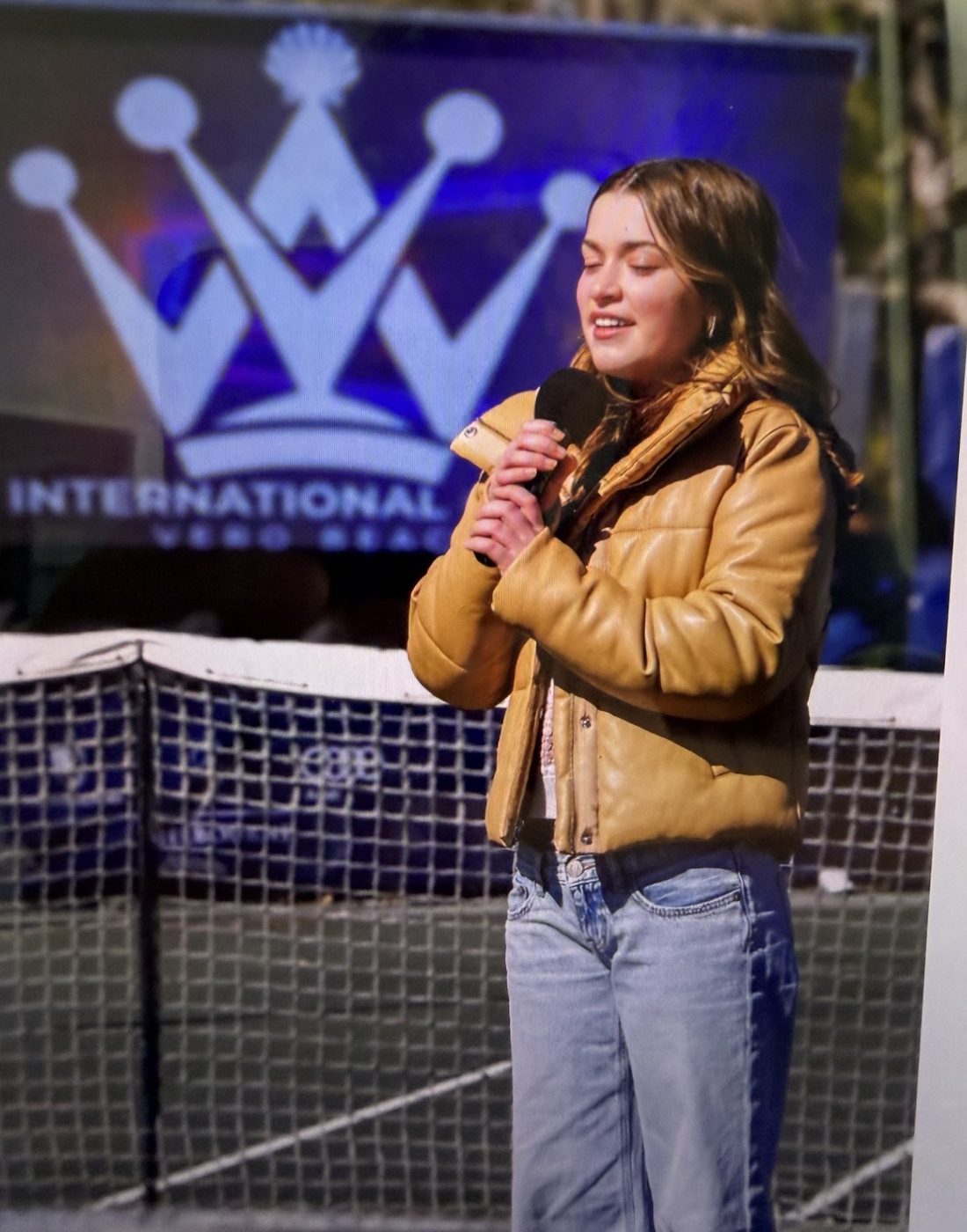 A singer performs the national anthem courtside at the Vero Beach International Tennis Open at Grand Harbor