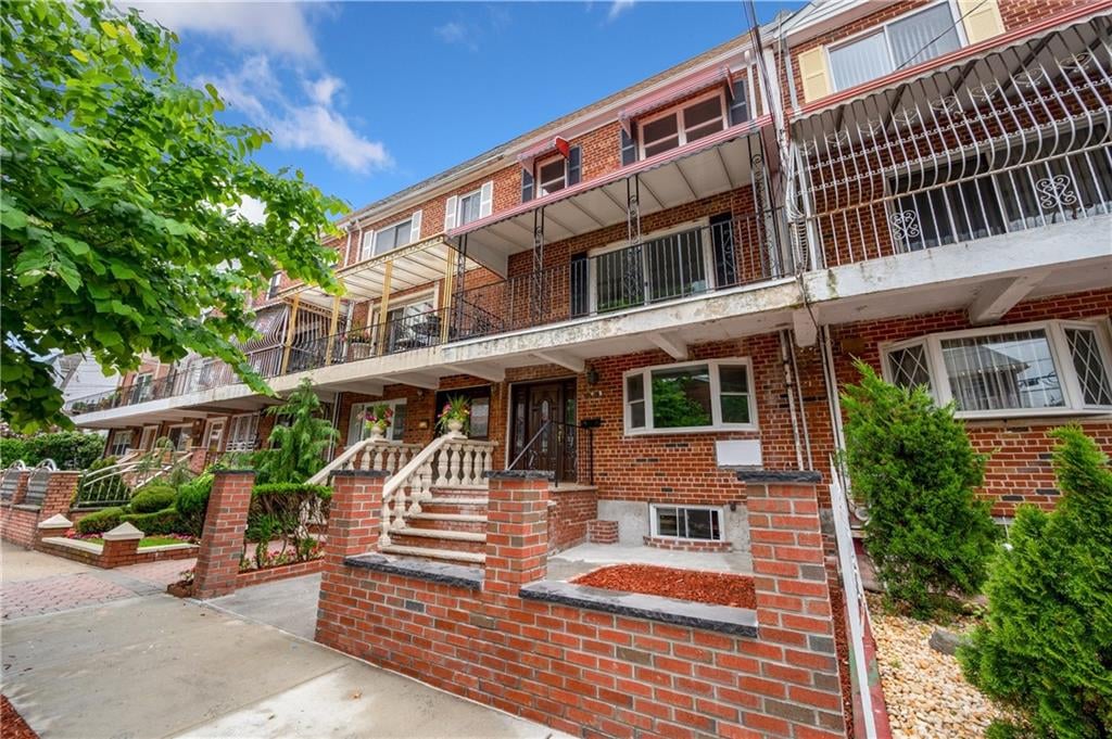 Exterior of 10518 Flatlands 4th St a 2-family brick townhouse sold in Canarsie Brooklyn by The Parviz Team