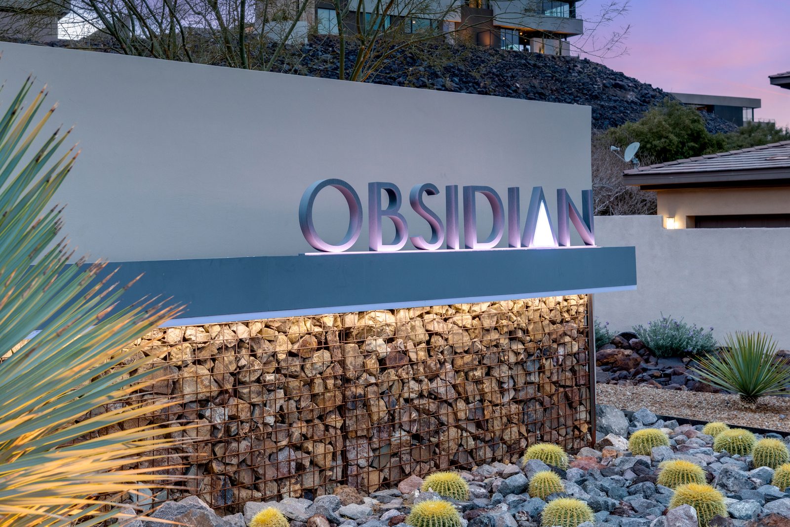 Obsidian sign on stone wall at dusk