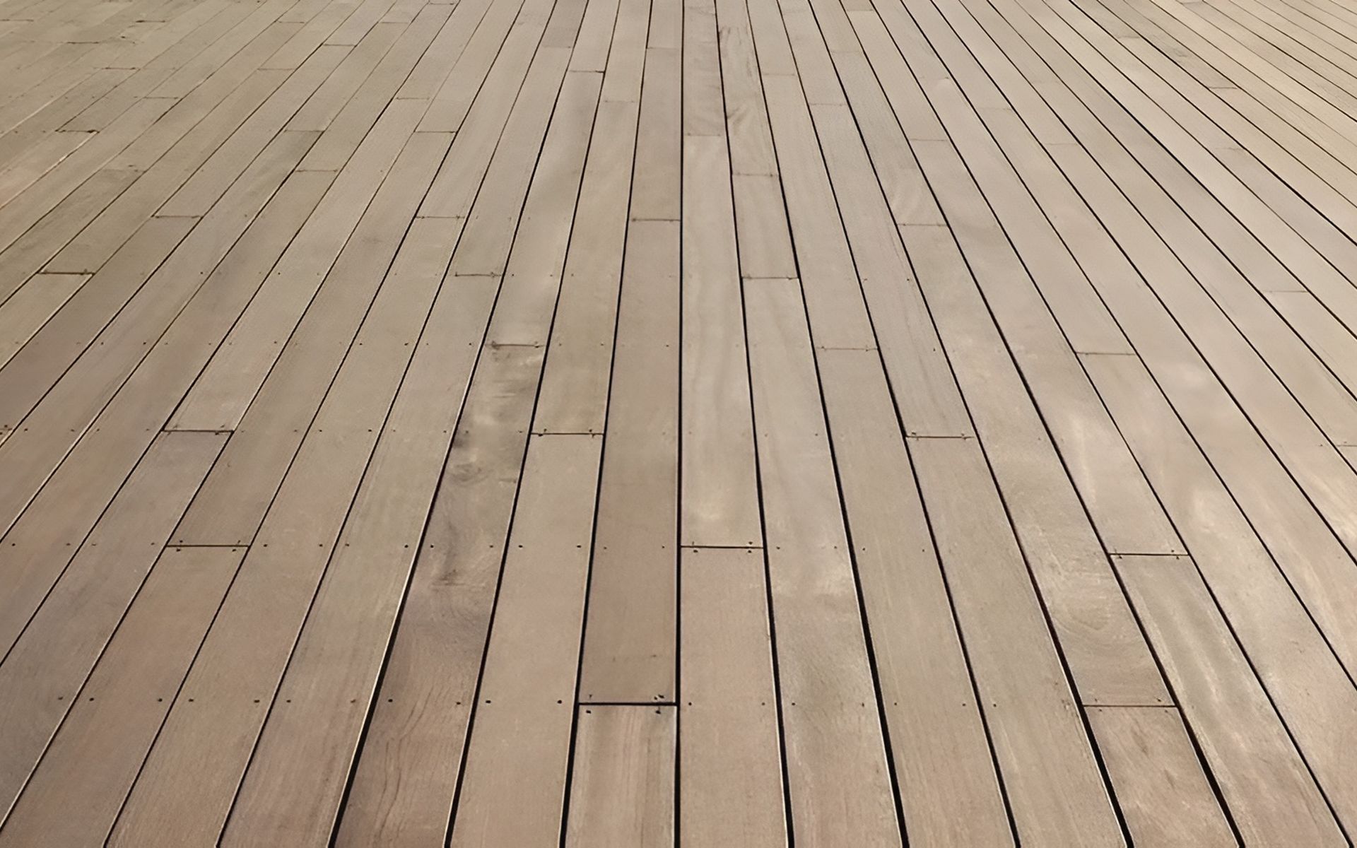 Light brown wooden flooring with long planks, visible grain, and dark seams.
