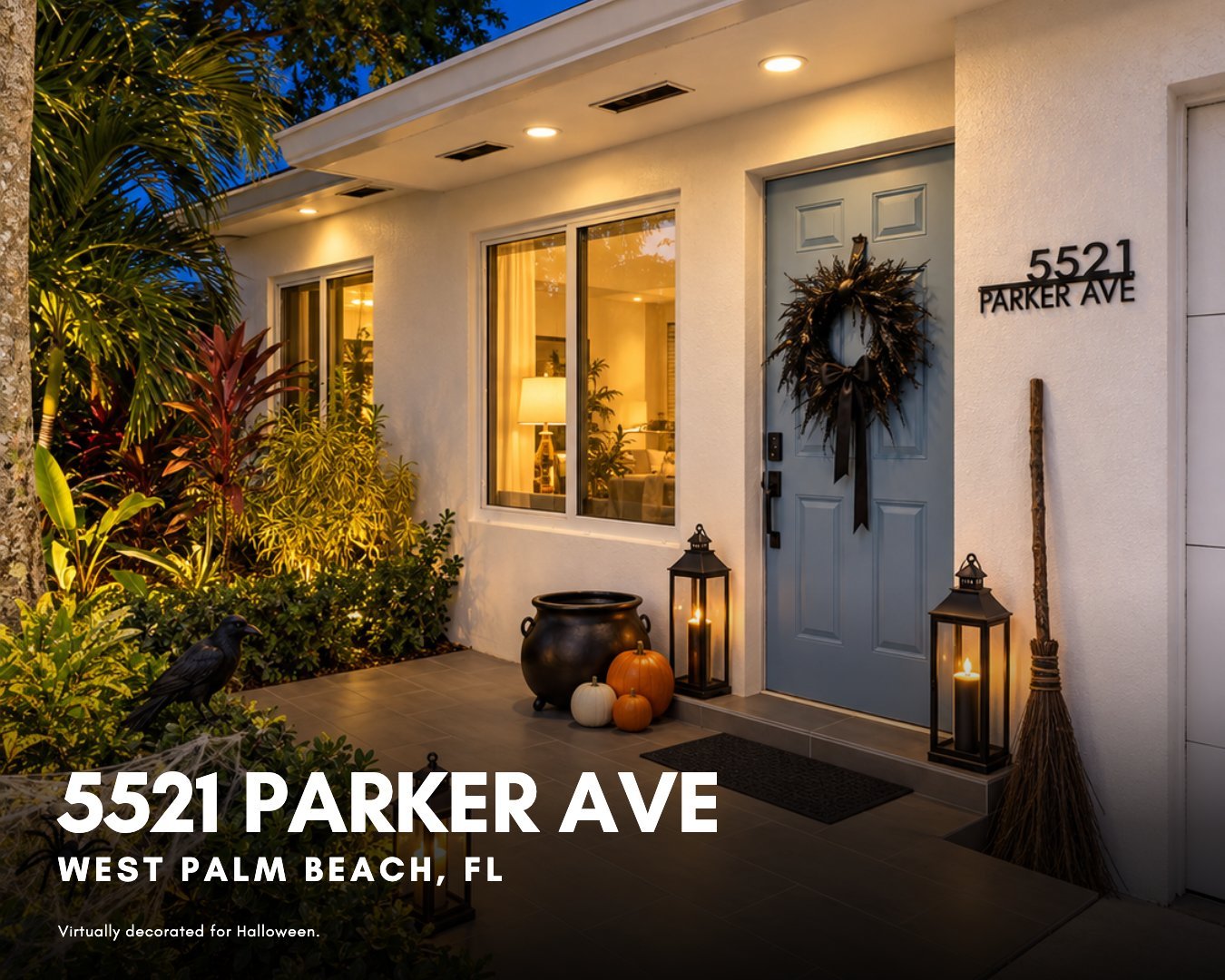Front entry of a renovated West Palm Beach home with a light blue door, porcelain tile porch, and tropical landscaping, virtually decorated with witch-themed Halloween decor