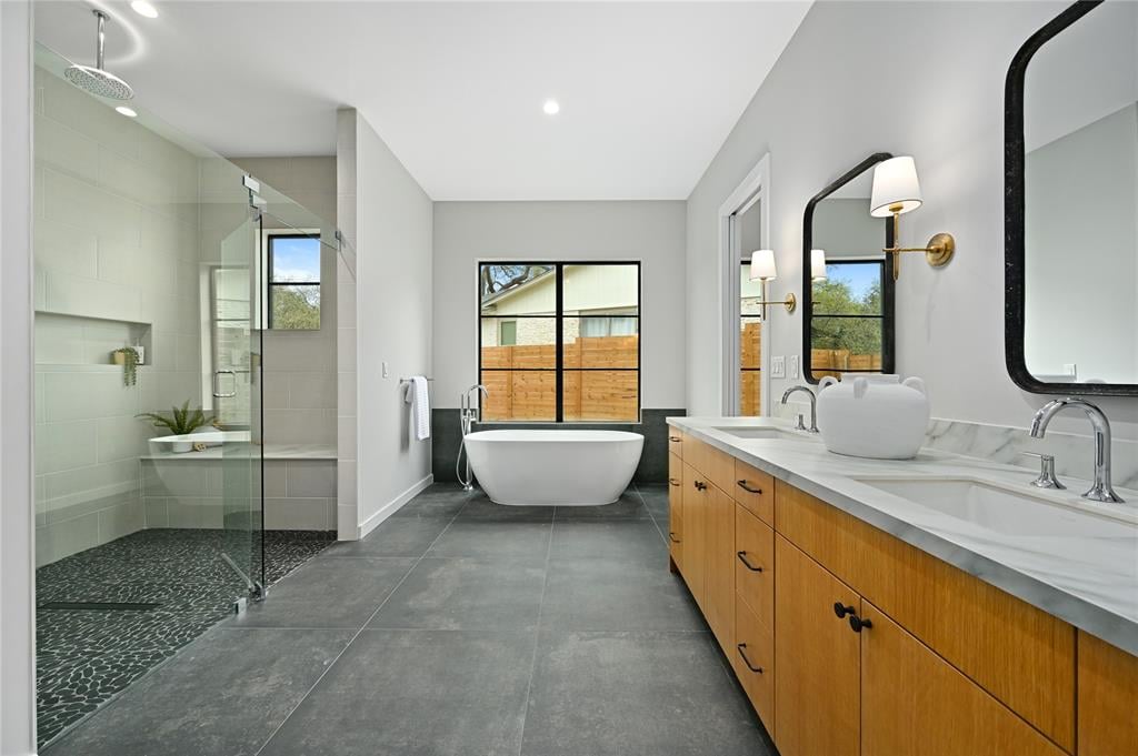 Primary bathroom at 2635 Barton Hills Dr, Austin, with a freestanding soaking tub, walk-in shower, and dual-sink vanity.