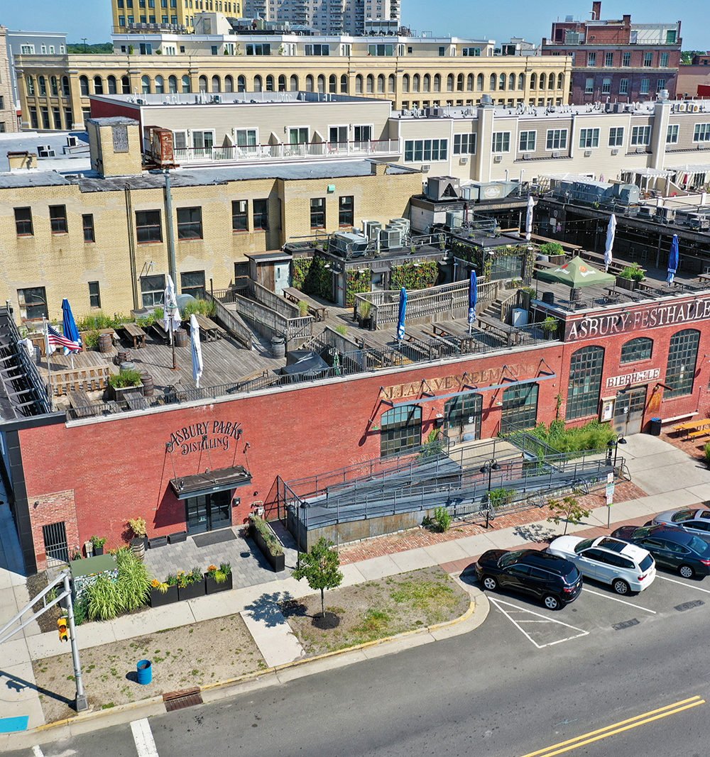 527 Lake Ave development with furnished rooftop terraces and a red-brick commercial façade.