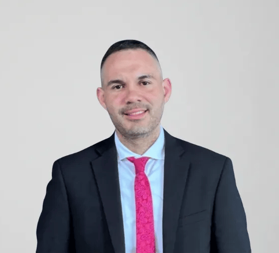 Financial Consultant and Real Estate Specialist in a pink tie.