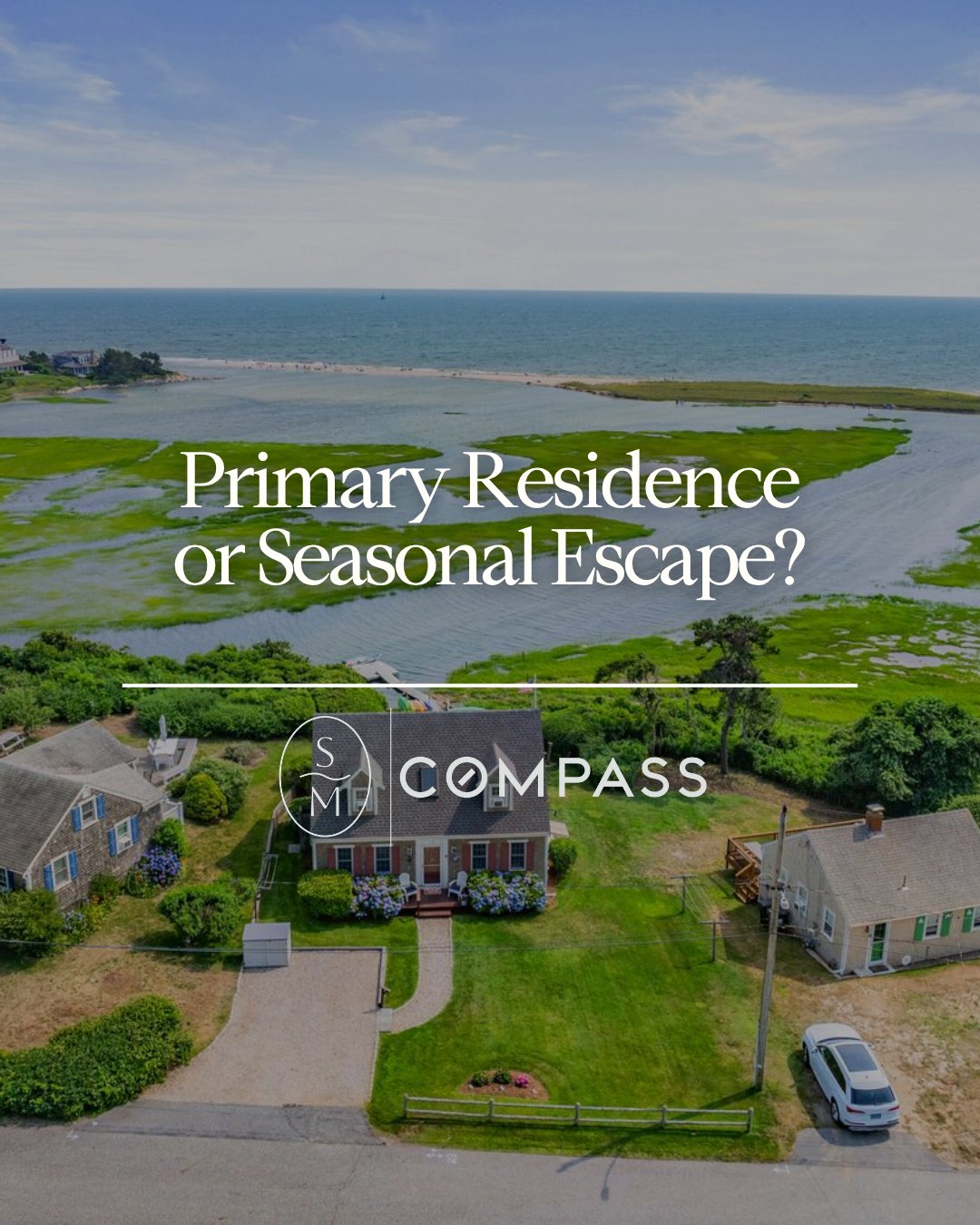 Aerial view of coastal homes beside a tidal inlet, marsh, and ocean beach.