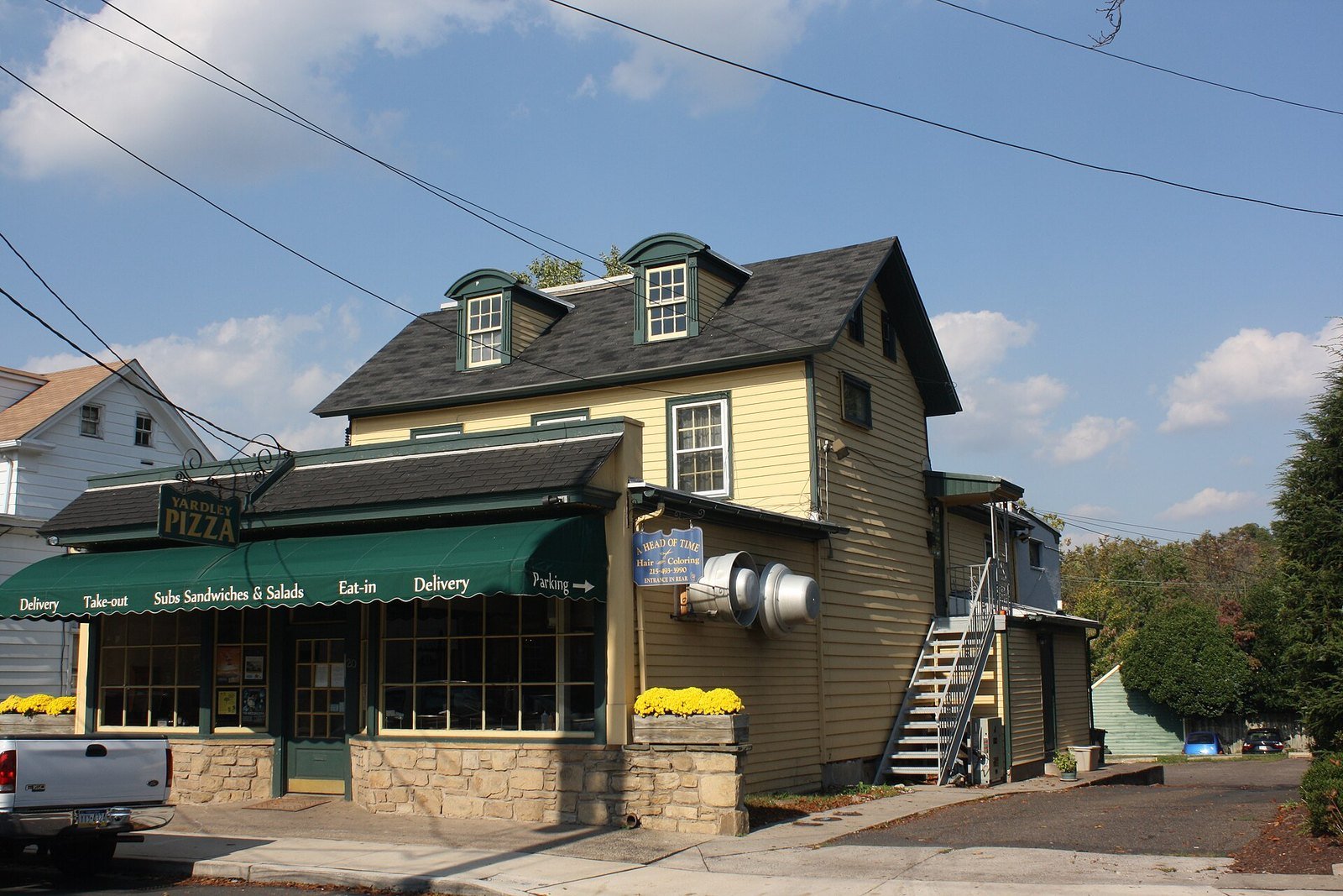 Historic storefront with a green awning on South Main Street under a blue sky in Yardley, PA