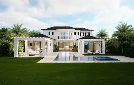 Modern white two-story home with a swimming pool, covered patios, and palm trees.