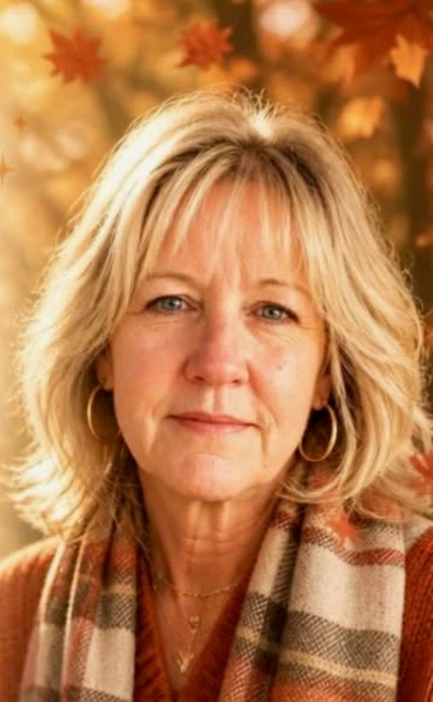 Bonnie Allamong wearing a plaid scarf and gold hoop earrings.
