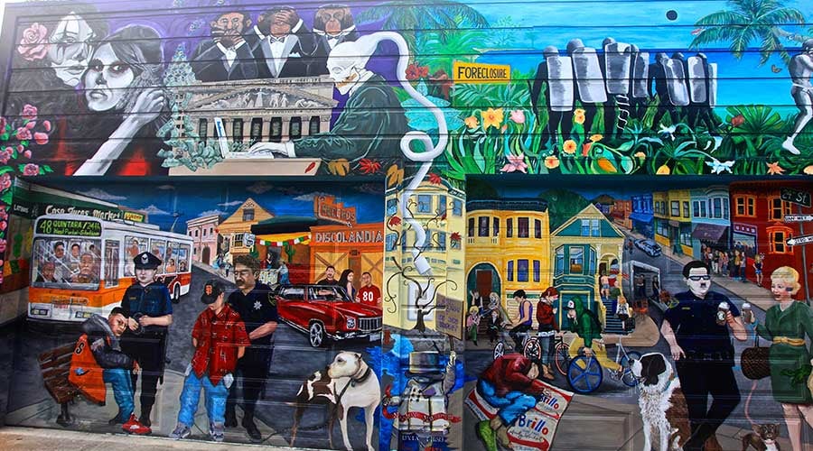 Balmy Alley in San Francisco's Mission District, featuring a narrow pedestrian pathway lined with vibrant murals depicting themes of social justice, cultural heritage, and community resilience.