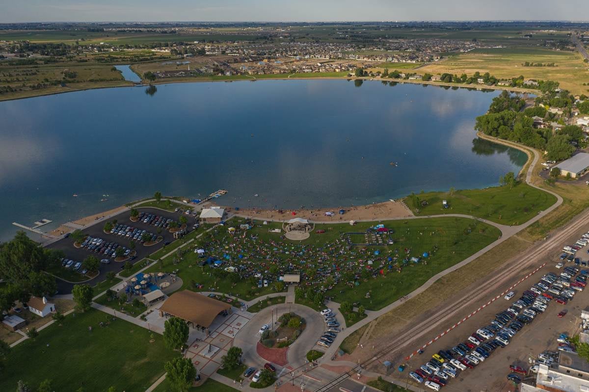 Aerial view of a Windsor lake and shoreline park during a crowded outdoor event.