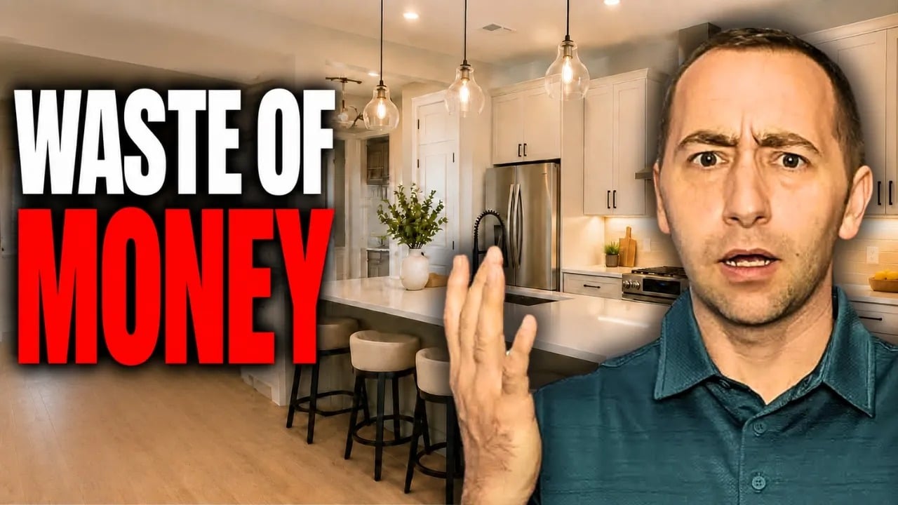 Real estate video thumbnail: a man gestures beside a remodeled kitchen and the words “WASTE OF MONEY.”