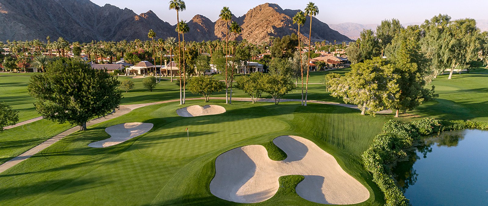 Golf course in La Quinta with palm trees and Santa Rosa Mountain views