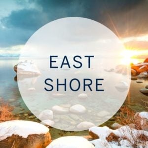 Lake Tahoe’s East Shore at sunset, with snow-dusted rocks along the water.