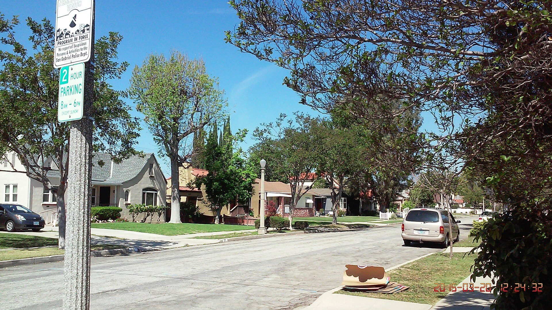 Detached houses and mature trees along a San Gabriel residential street, photographed March 2015
