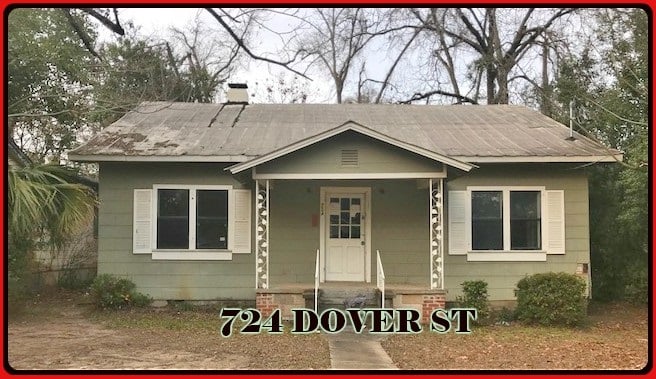 A small house displaying the address "72 Dover St" prominently on its exterior.