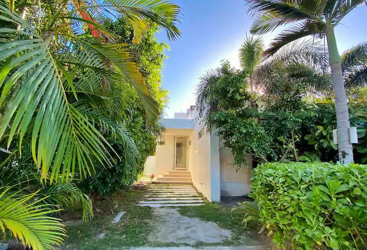 Unique tropical waterfront 3 bed 3 bath villa with a pergola and plunge pool on the rooftop terrace and with boat slip in a gated community on Ambergris Caye, Belize. 