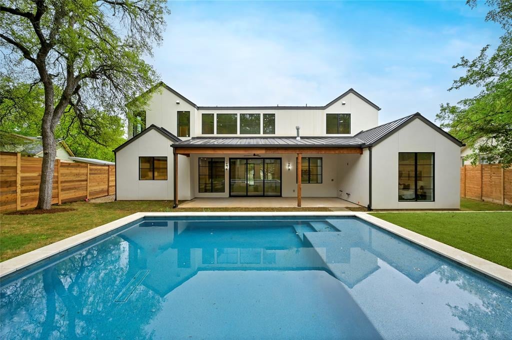 Rear exterior of 2635 Barton Hills Dr in Austin's Barton Hills neighborhood, showing the pool and covered patio.