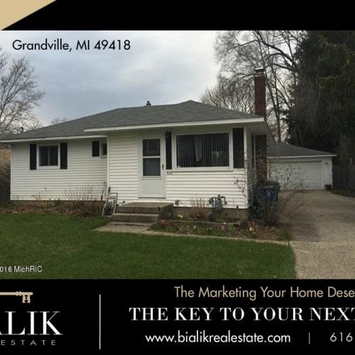 Bialik Real Estate marketing graphic featuring a white house in Grandville, Michigan.