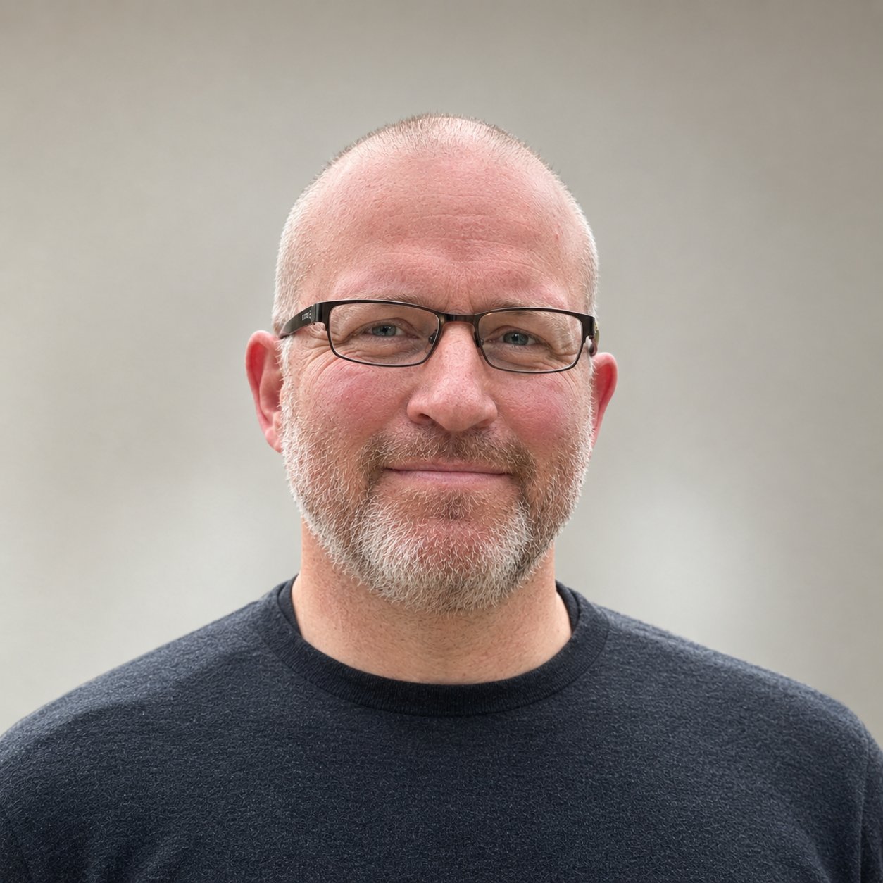 Matt Corwin wearing rectangular glasses and a dark sweater.