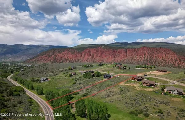 Aerial view of 4 Mile Ranch with homes, roads, parcel lines, and red-rock mountains.