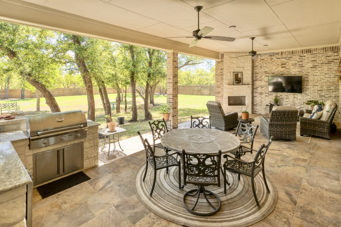 Immerse yourself in the luxurious outdoor living experience offered by this remarkable home. Step onto the expansive covered patio, As you set foot on the tiled flooring of the patio, you'll immediately appreciate its durability and aesthetic appeal. The tiles not only add a touch of sophistication to the outdoor space but also ensure easy maintenance, allowing you to enjoy your patio year-round without worry.