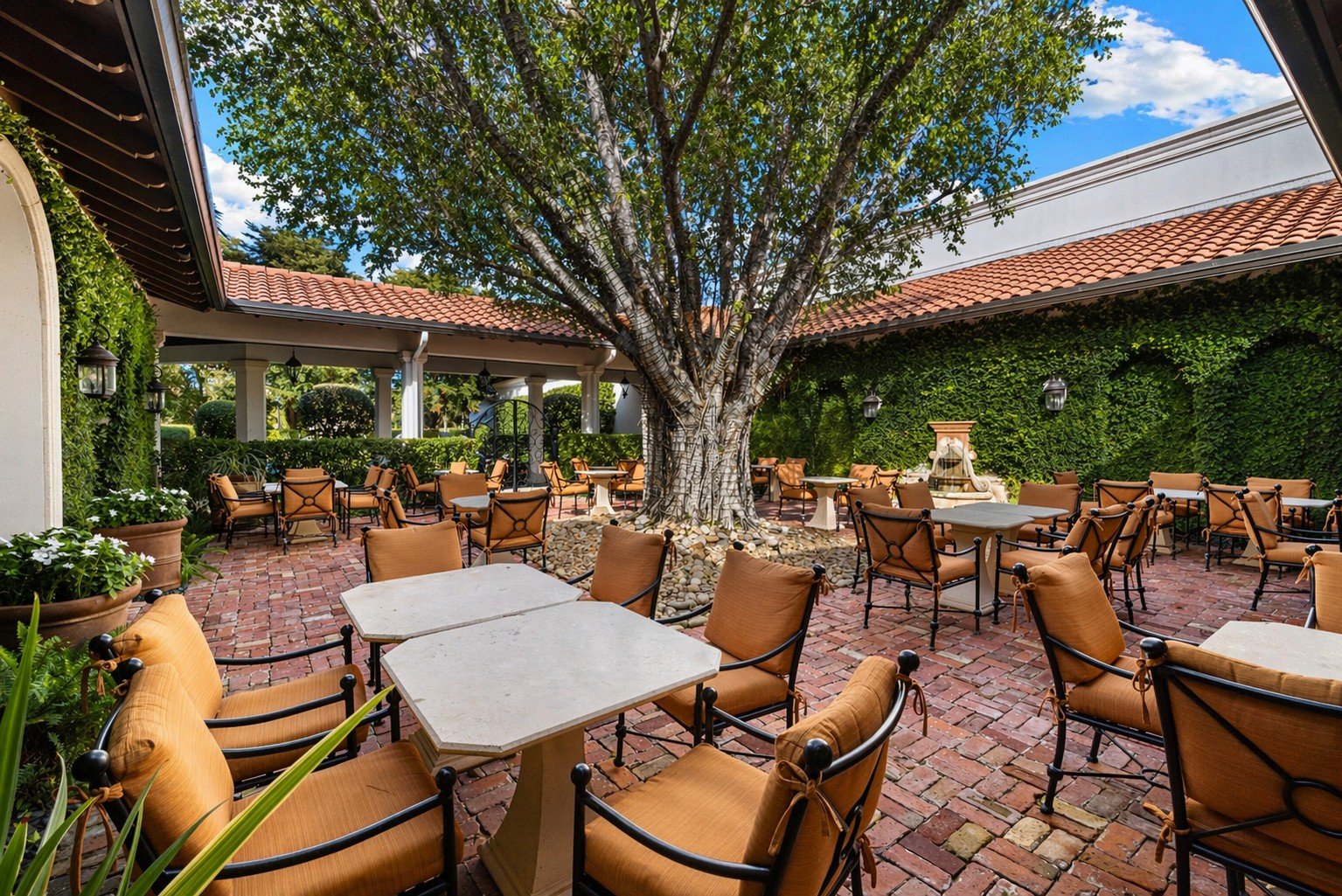 Outdoor dining under a shade tree at Miromar Lakes Beach & Golf Club