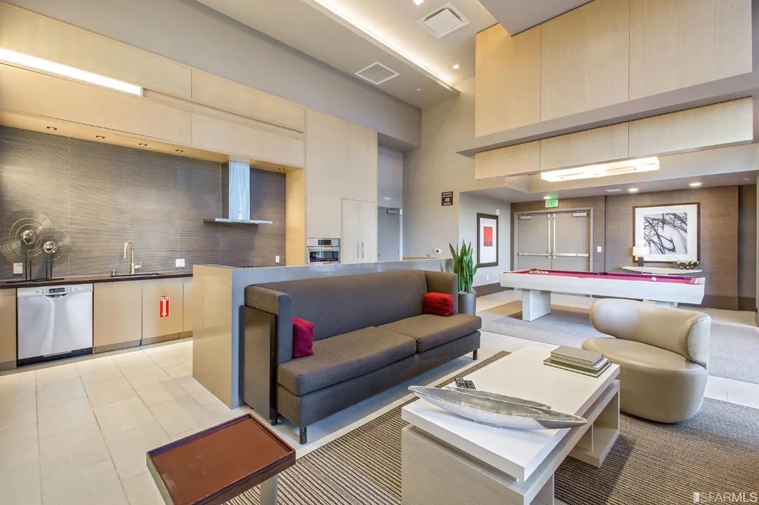 Arden Residences common area with kitchen, pool table, and lounge seating.