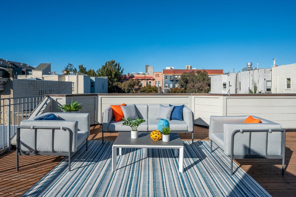 Roof deck view overlooking Lower Pacific Heights, San Francisco, with nearby city buildings and neighborhood charm.