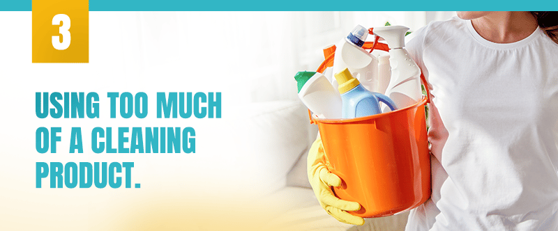 Cleaning tip 3: using too much of a cleaning product, illustrated by a cleaner holding supplies.
