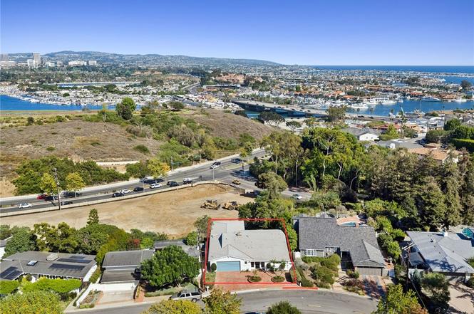 Older single-story teardown home on a large lot in Newport Beach, California, being evaluated for a custom rebuild