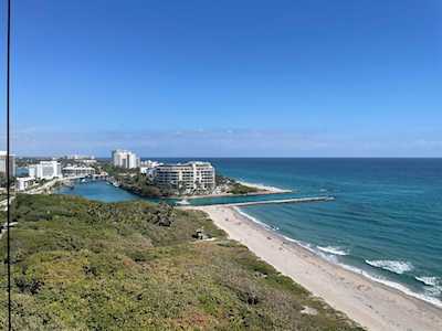East Boca Raton coastline with beachfront buildings, coastal vegetation, and a sandy beach beside the Atlantic.