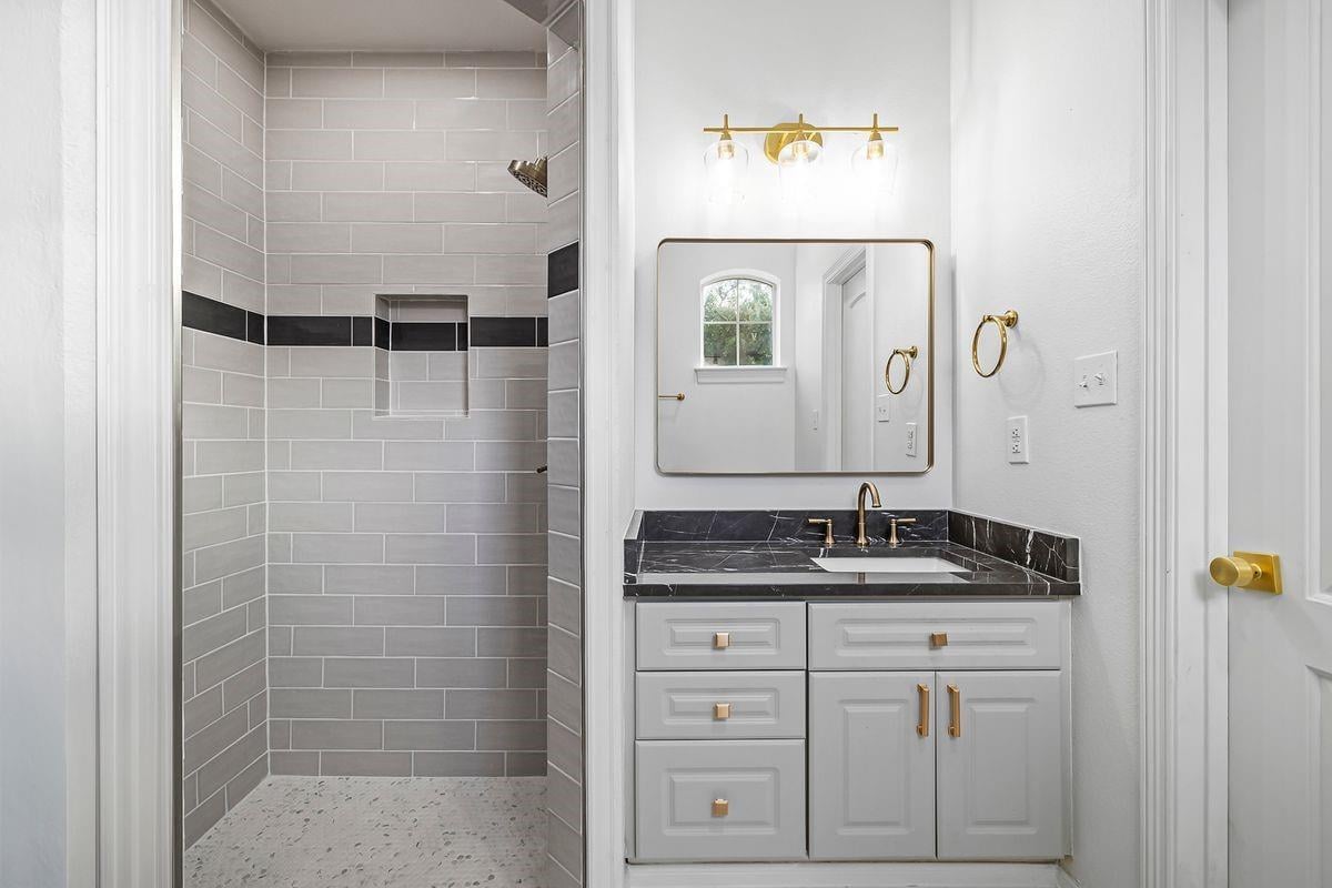 Secondary bath with tile shower and brass fixtures, Barton Hollow, Westlake, Austin.