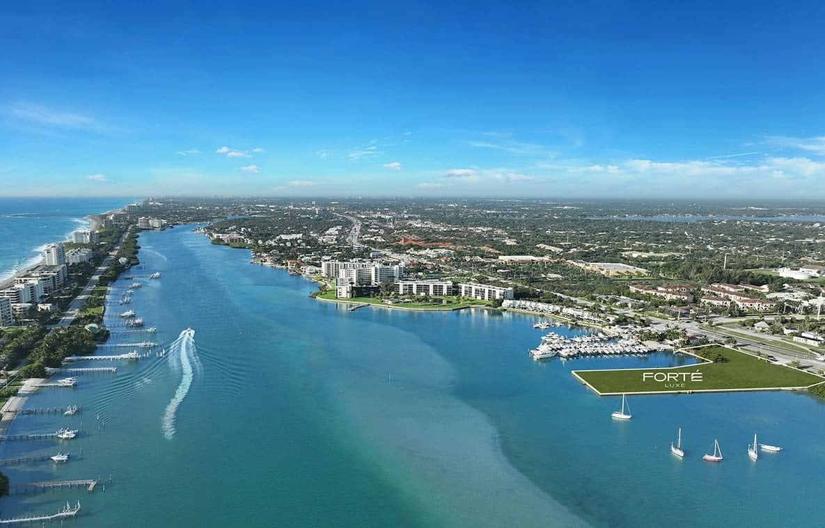 Aerial view of the Forte Luxe waterfront site, with a marina, boats, and the ocean beyond.