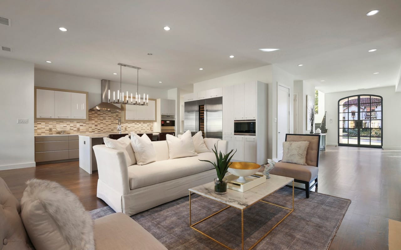 Spacious open-concept living room and kitchen, blended with complementary colors for a cohesive and inviting design.