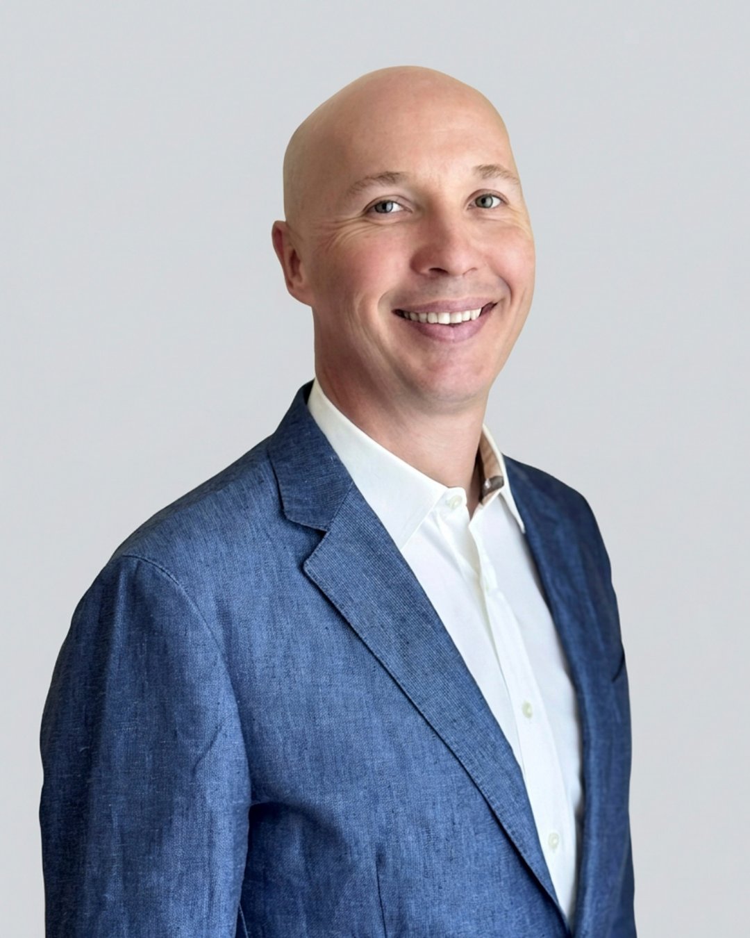 Yegor Yegorov smiling in a blue blazer and white shirt.