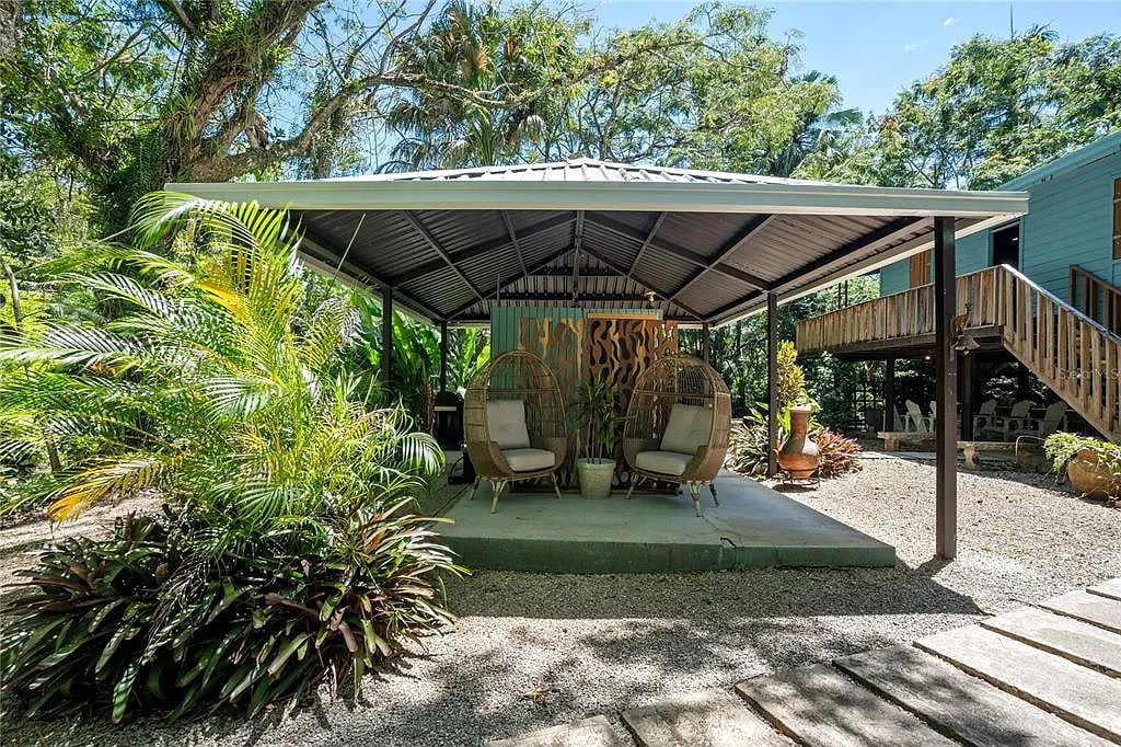 Covered patio with hanging wicker chairs