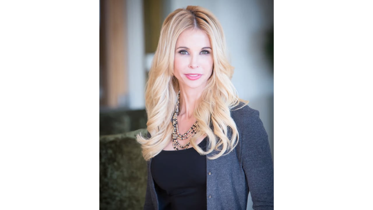 Heather MacFarland wearing a gray blazer and layered necklace.
