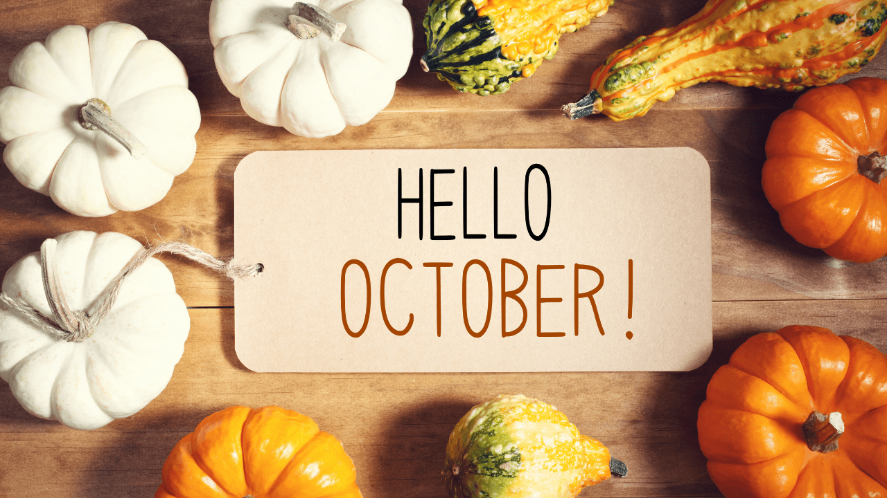 A seasonal display with pumpkins and a sign that says, "Hello October!" 