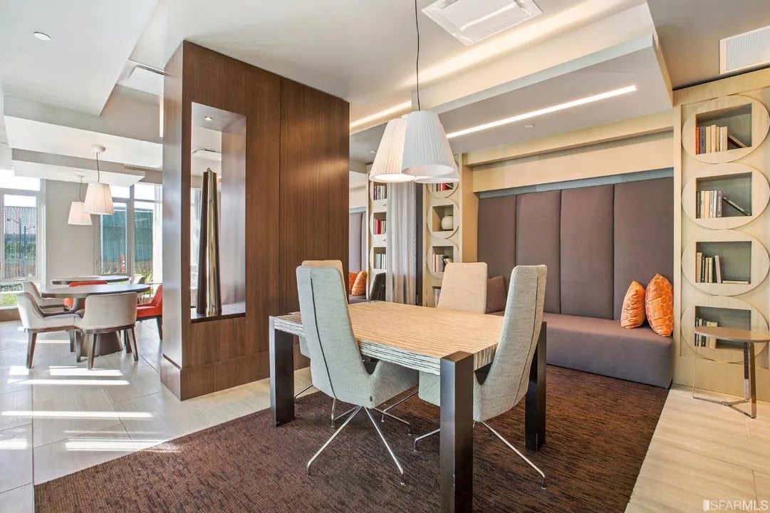Arden Residences elegant co-working space featuring dining table, geometric bookshelf wall, contemporary furniture, and natural light in Mission Bay San Francisco