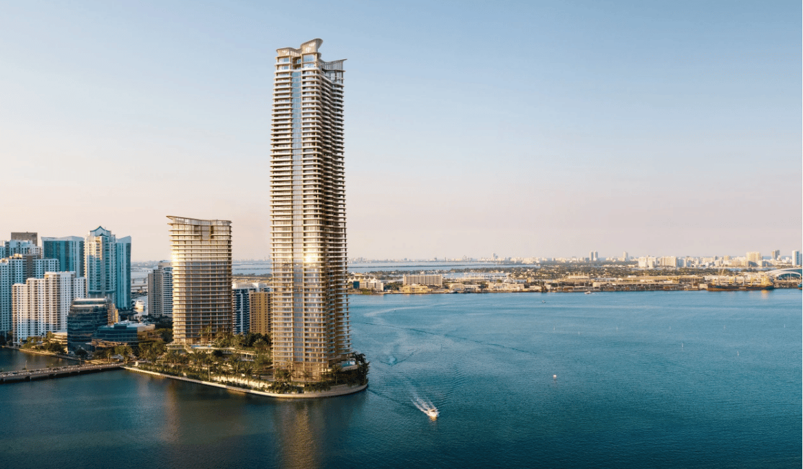 Waterfront residential towers beside Biscayne Bay, with Miami’s skyline across the water.